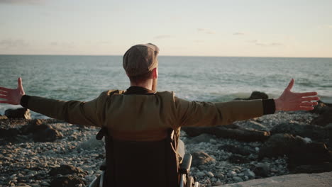 disabled man enjoying the beach sunset