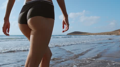 girl walks the beach and in the water