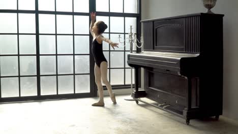 4k tracking wide shot happy little cute child girl dancer in black leotard and ballet slipper shoes jumping and dancing contemporary ballet dance at vintage studio room