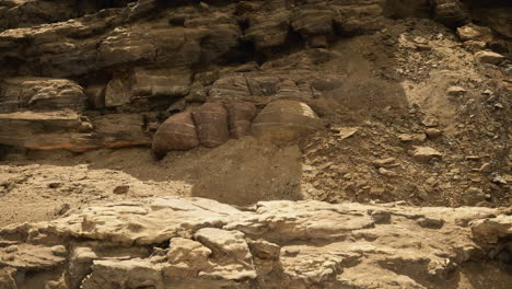 large rock formations are visible at a remote desert location during daytime