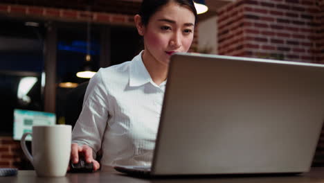 Worker-working-late-at-night,-typing-on-laptop-keyboard