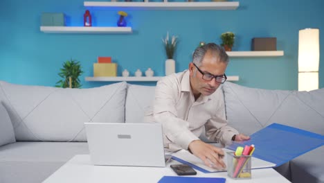home office worker man reviewing paperwork files.