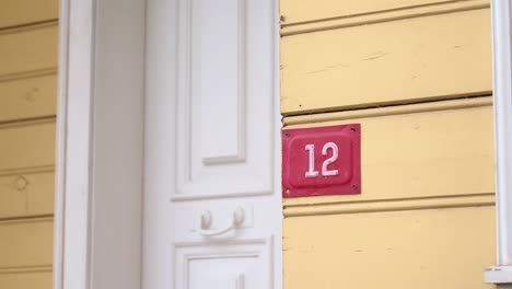 house number 12 on a yellow house