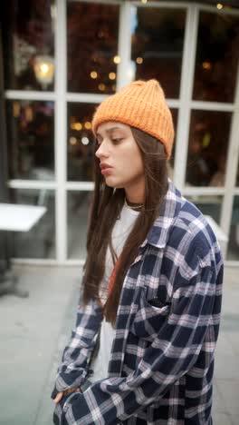 young woman in trendy outfit on a city street