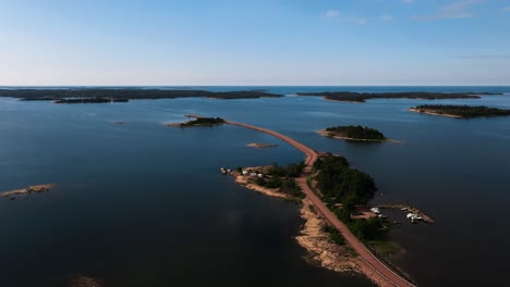 aerial view rising in front of a road, connecting islands in vardo, aland, finland