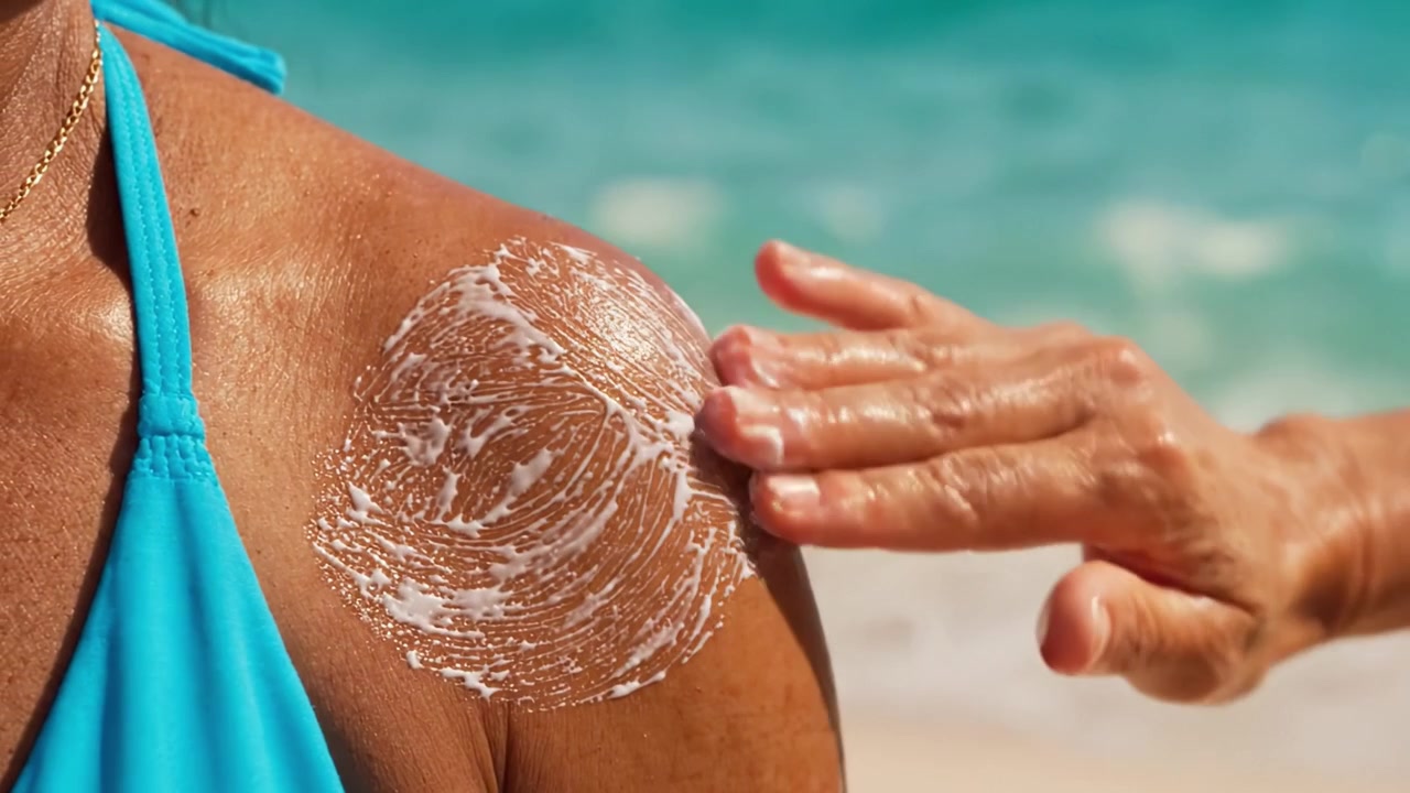 A Detailed View of Sunscreen Application on Shoulder at the Beach, Highlighting Skin Protection and Summer Recreation Under the Sunlight