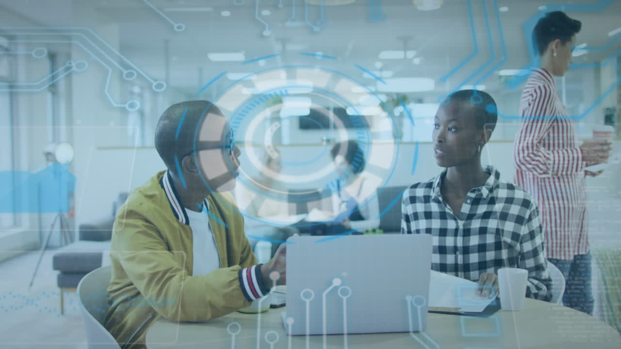 Animation of data processing over african american male and female colleagues discussing at office