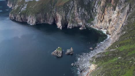 Drone video flying right to left at Slieve League, Ireland at sunset