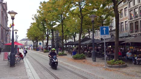 people enjoying at the place du marché square in the city center of liège, belgium