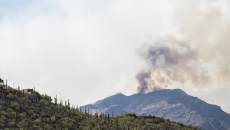 Timelapse-of-Dense-Smoke-and-Ash-Going-Into-Atmosphere-Above-Mountain-Peak,-Day-to-Night