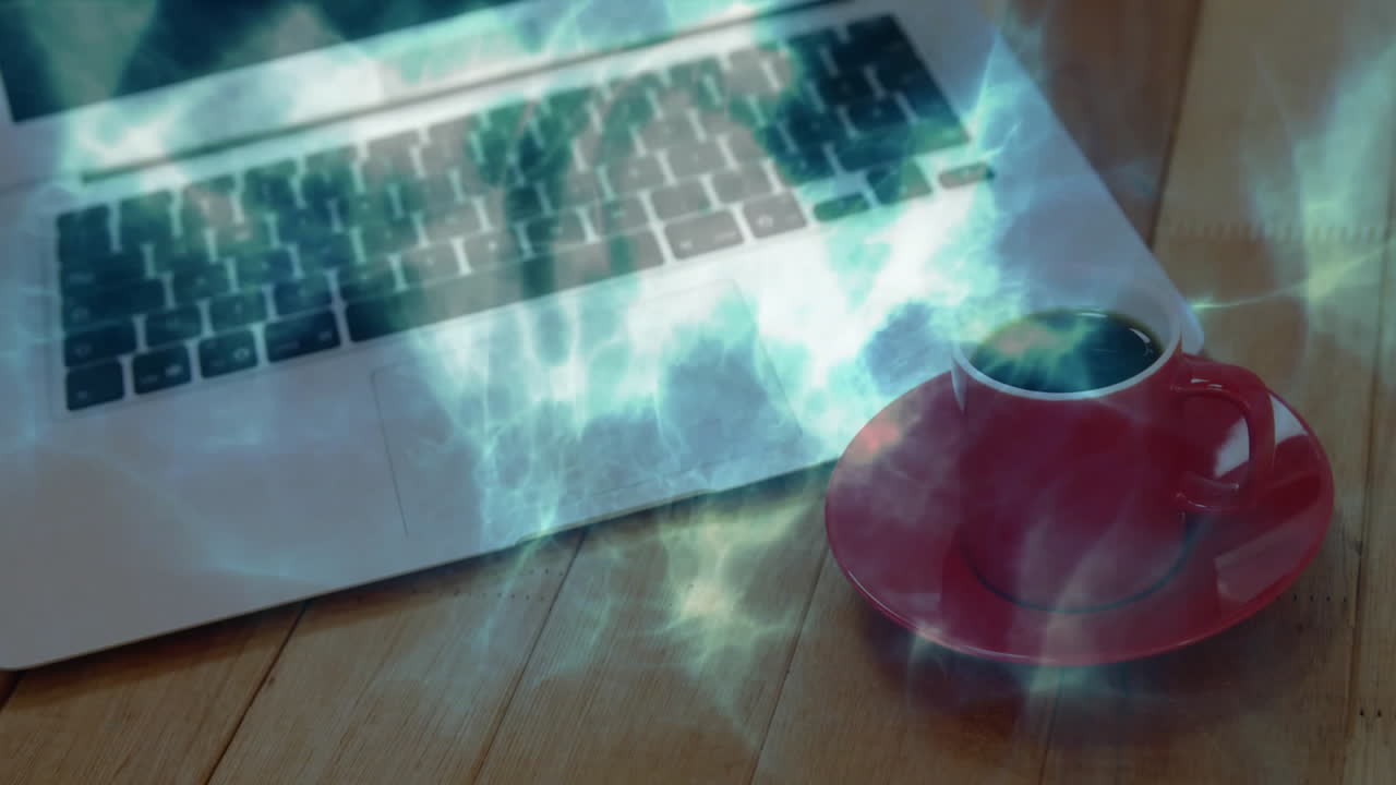 Animated illustration showing laptop keyboard and red coffee cup glowing under bluish-green energy