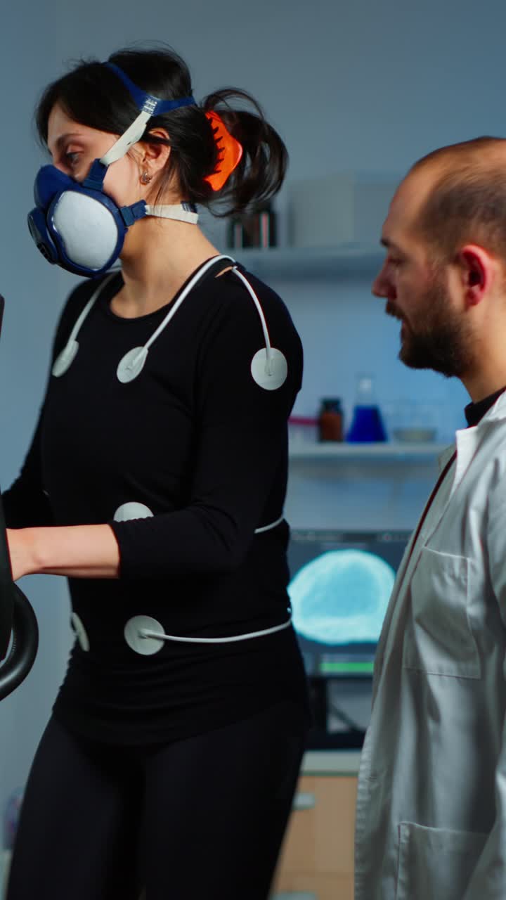 Woman undergoes metabolic exercise testing with a scientist in a laboratory