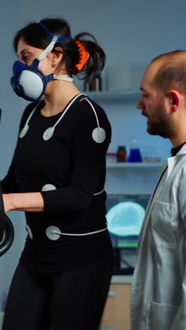 woman undergoes metabolic exercise testing with a scientist in a laboratory