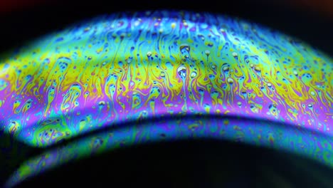 4k stable shots of soap balloons showing the colors of the macro world through a microscope perspective
