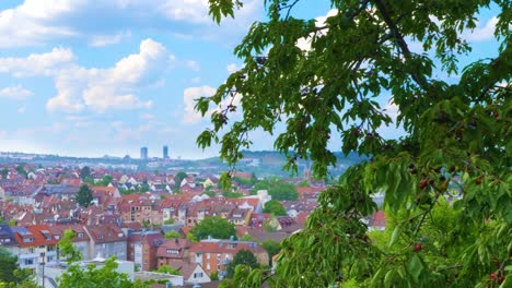 Panoramic-pan-across-Stuttgart,-southern-German-town,-blue-sky-and-red-rooftops