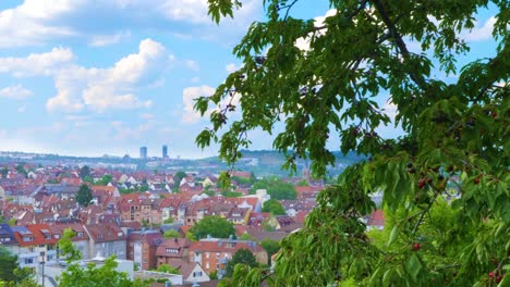 panoramic pan across stuttgart, southern german town, blue sky and red rooftops