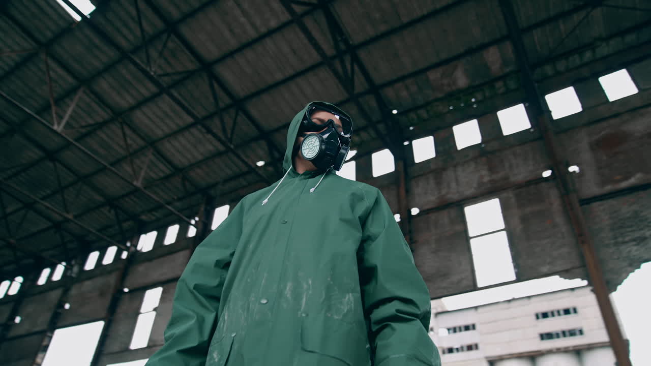 Man in gas mask on ruins. Man with gas mask and decontamination suit