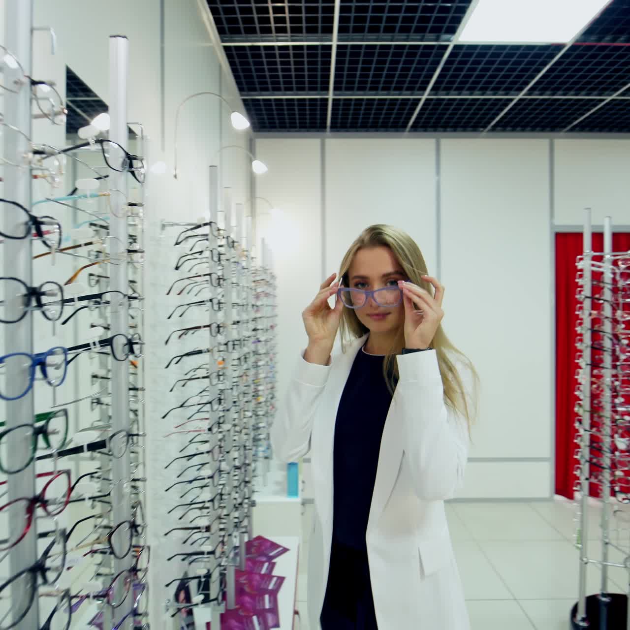 Woman buying glasses in shop