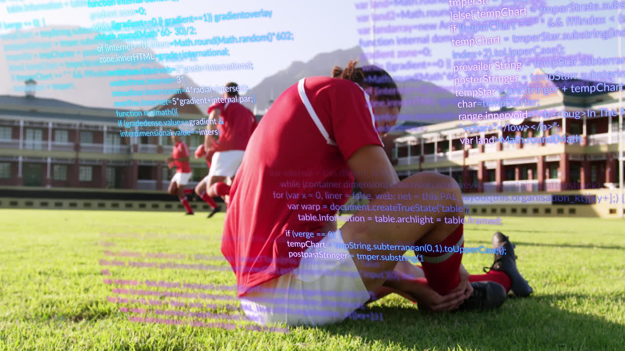 Animation of computer language over caucasian soccer player lying on ground in pain