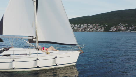 woman relaxing on a sailboat deck