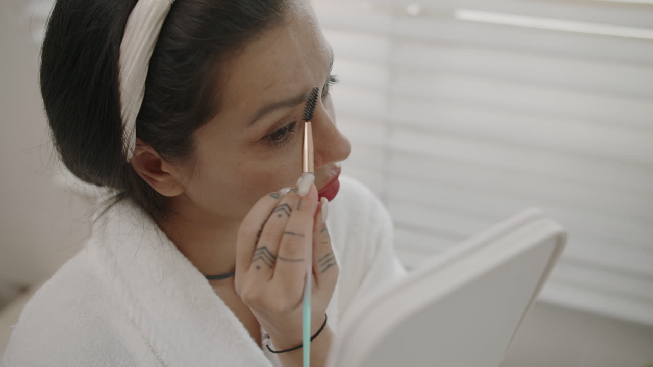 Young Brunette Using Brush when Shaping Eyebrows