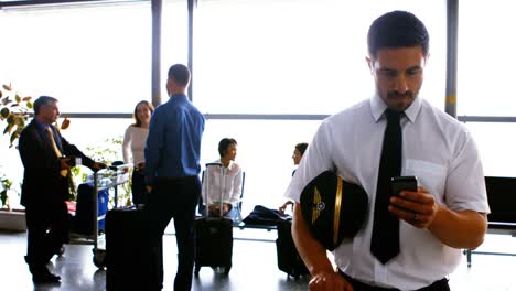 pilot using mobile phone while commuters interacting with each other