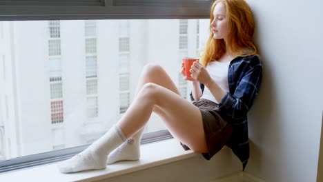 Woman-having-coffee-at-home-4k