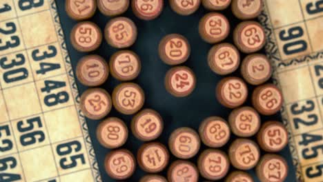 cinematic close-up rotating smooth zoom out shot from above of a pile of bingo wooden barrels in a square, woody figures, old numbers background, vintage board game, professional lighting, 4k video