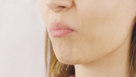 close-up of woman eating almonds.