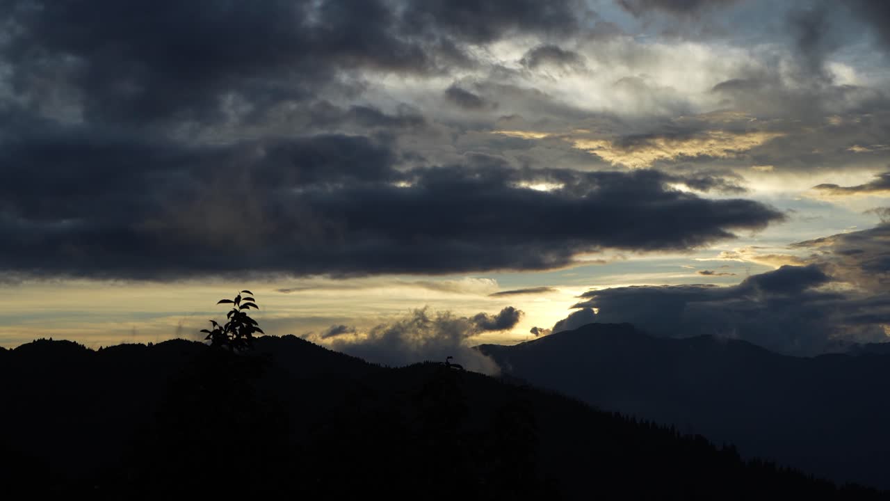 Sunset between mountains and clouds