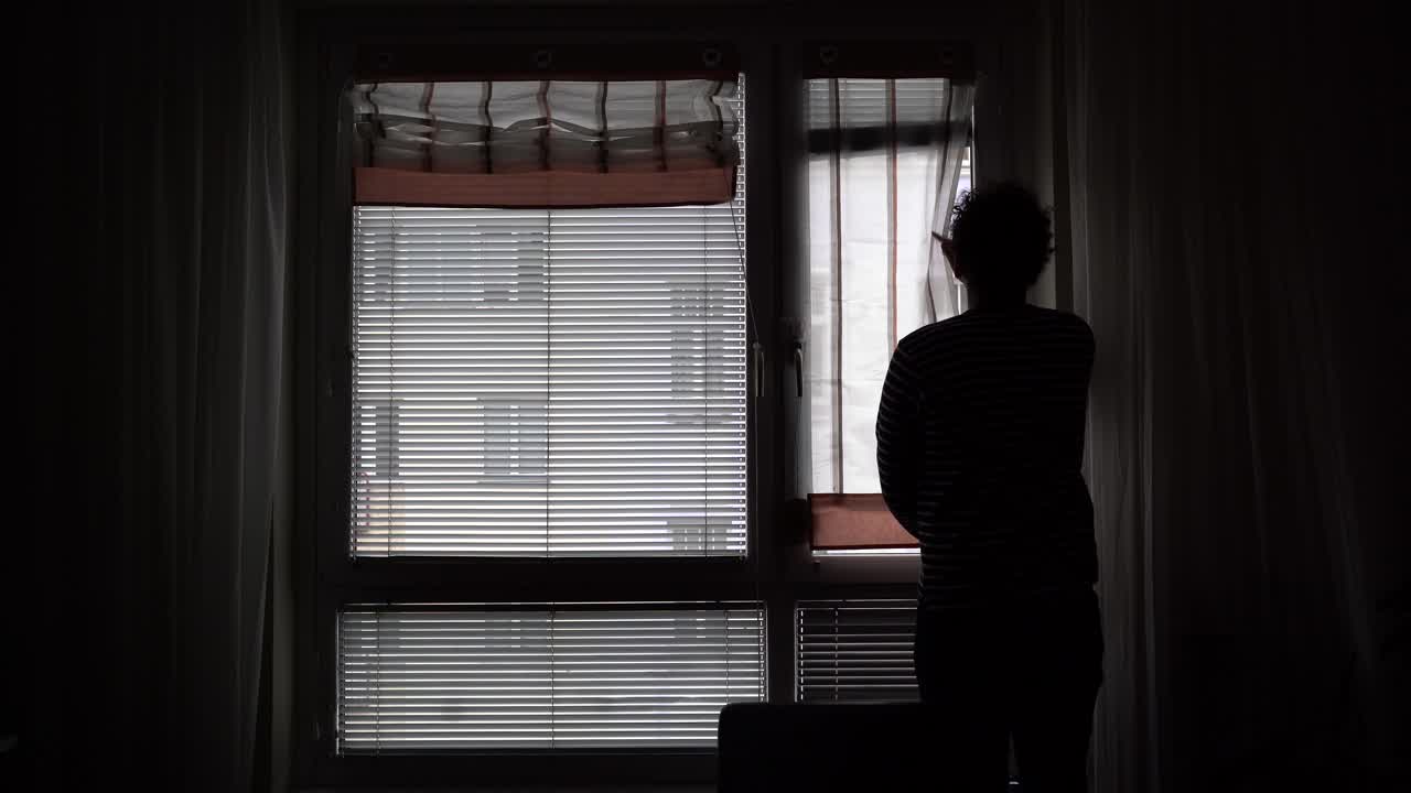 Silhouette Of A Man Slowly Opening The Window Curtains - Close Up Shot