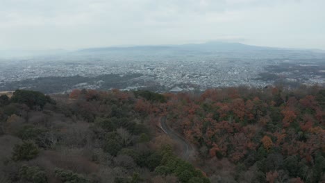 Serpentine-road-leading-through-mountains-to-city-of-Nara,-Japan