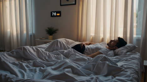 a couple relaxing in bed in the morning