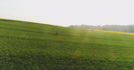 Agriculture-Male-Farmer-Walking-On-Track-Over-Agricultural-Field-While-Using-Digital-Tablet-13