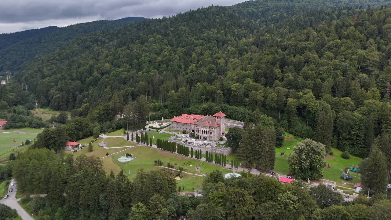 Scenic view of Cantacuzino Castle in lush Romanian forest