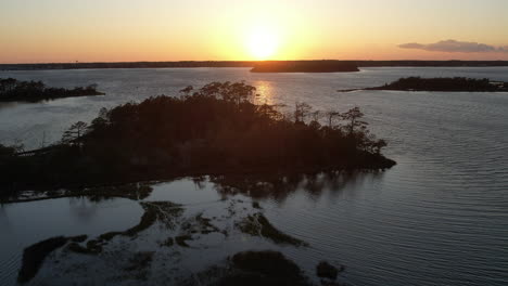 Aerial-shot-of-the-salt-marsh-or-wetlands,-epic-drone-shot-into-the-sun