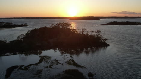 aerial shot of the salt marsh or wetlands, epic drone shot into the sun