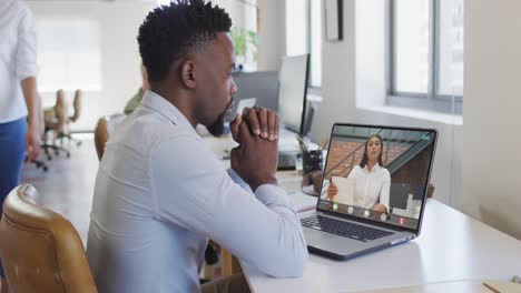 African-american-businessman-using-laptop-for-video-call-with-biracial-business-colleague