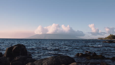 Clouds-Covering-Peak-Of-West-Maui-Mountains-Seen-From-Rocky-Beach-In-Wailea,-Maui,-Hawaii