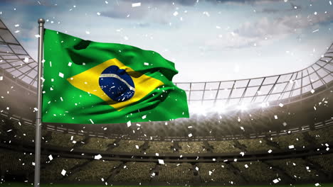 confetti falling over waving brazil flag against sports stadium in background