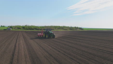 tractor planting seeds in field
