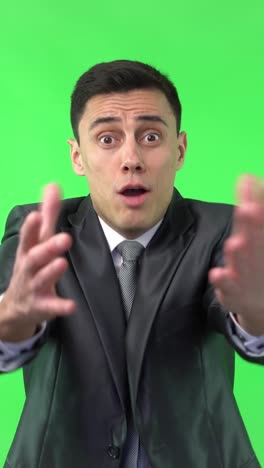 businessman in suit expressing various positive emotions on green screen