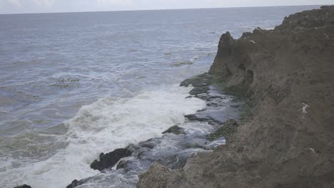 view of ocean waves crashing against rugged coastal rocks, video raw c-log 8bits