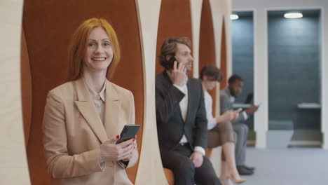 portrait of cheerful caucasian businesswoman using phone