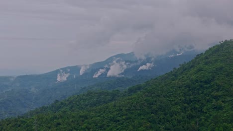 drone flies through tropical forest toward geothermal steam vents above ormoc, leyte, philippines.