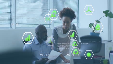 Animation of icons and computer language over diverse coworkers discussing reports