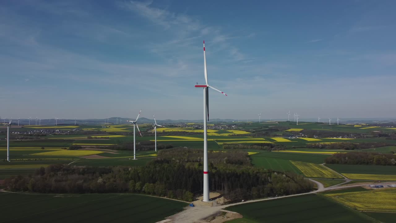 Aerial View Of Wind Turbine Under Construction In Scenic Farm - drone shot arc