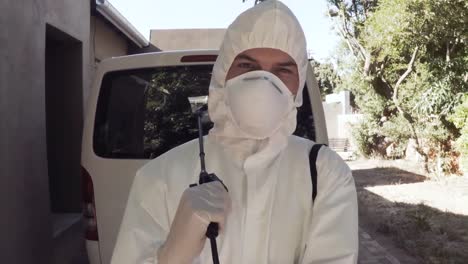 pest control man standing next to a van