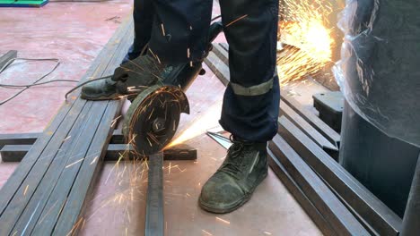 unrecognizable worker cutting iron with a radial