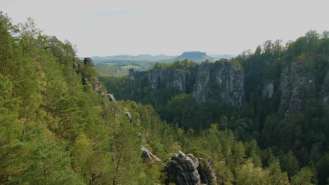 elbsandsteingebirge sachsen elbe sandstone formations rising above dense green forests mountains, showcasing the region’s natural beauty and rugged terrain